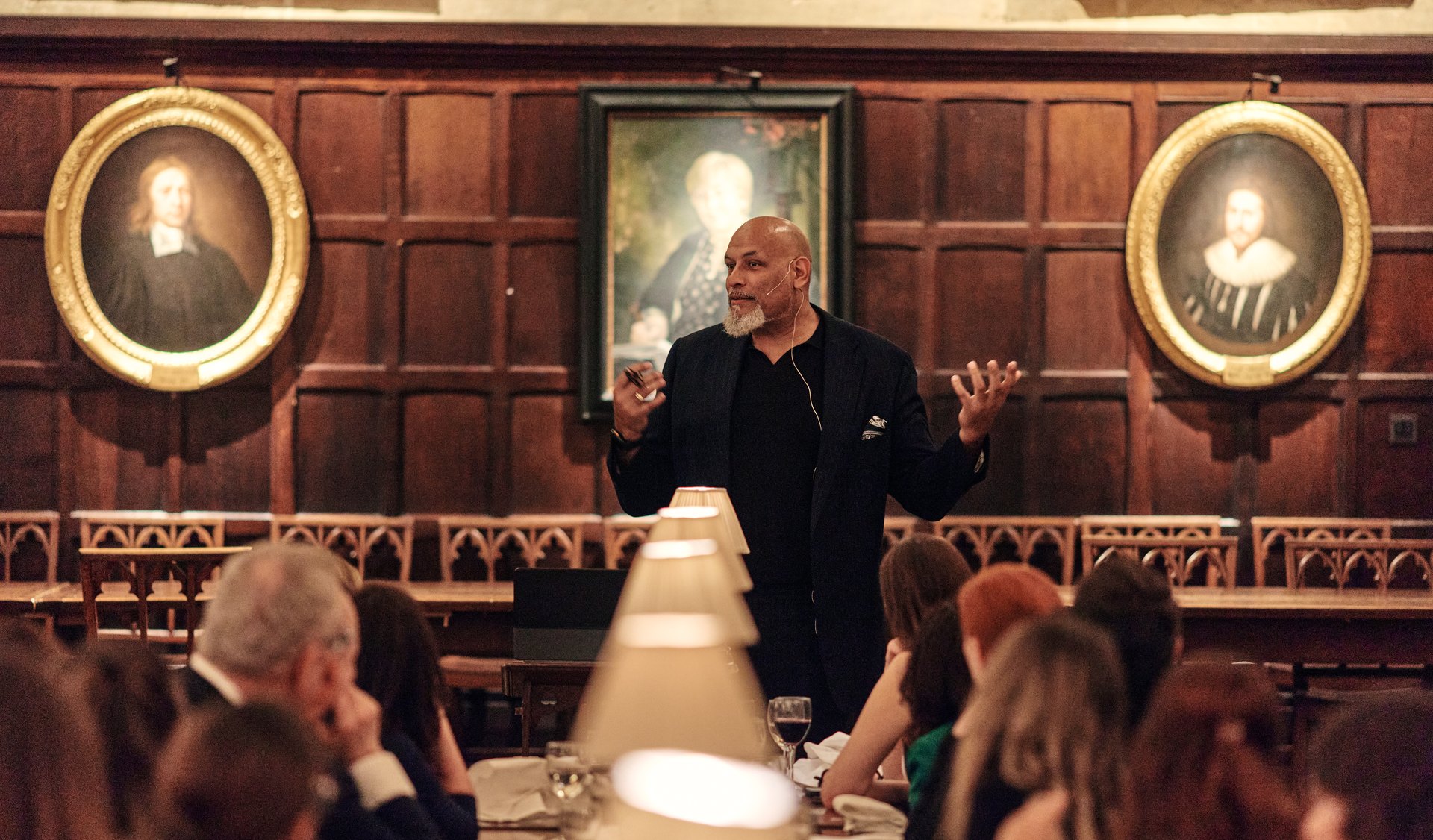 Professor John Amaechi OBE speaking with a headset microphone